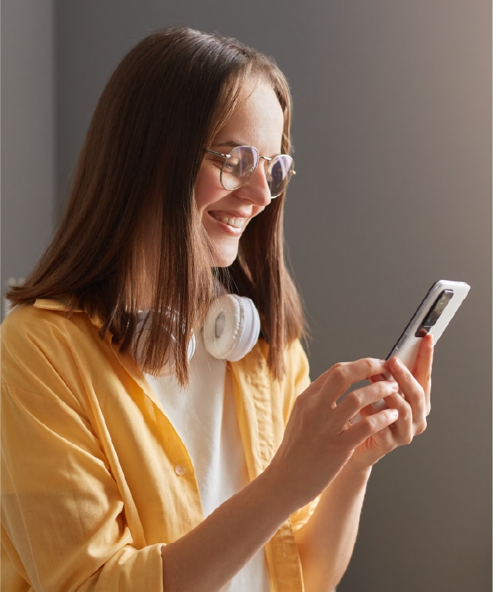 A woman uses a password to unlock her smartphone, an example of cybersecurity basics. 