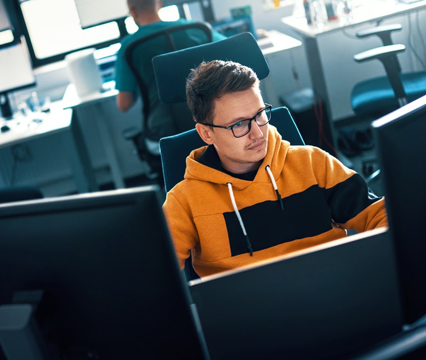 A man researches hacktivism on his computer.