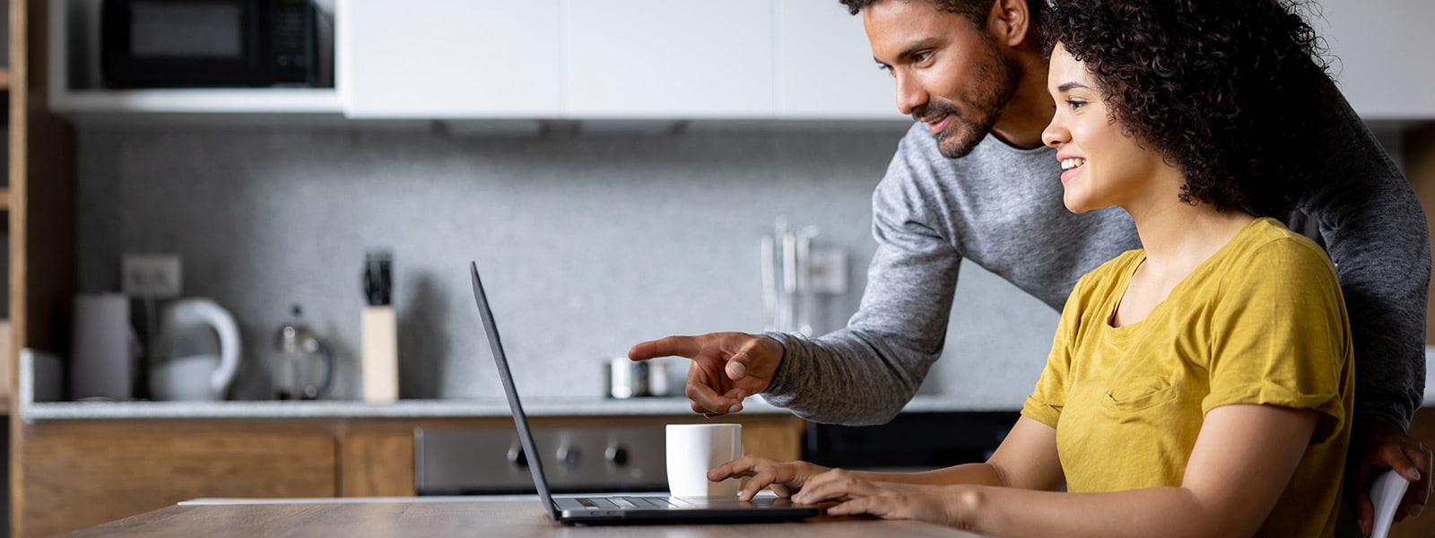 Photo of a man and woman looking at a computer learning how a VPN works.