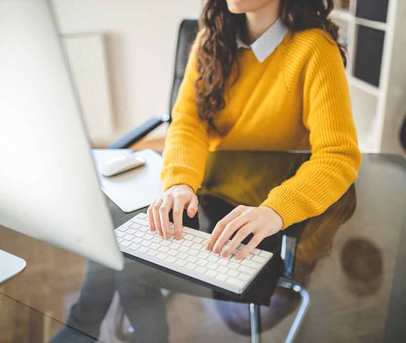 Person typing on a computer to search for how to block websites.