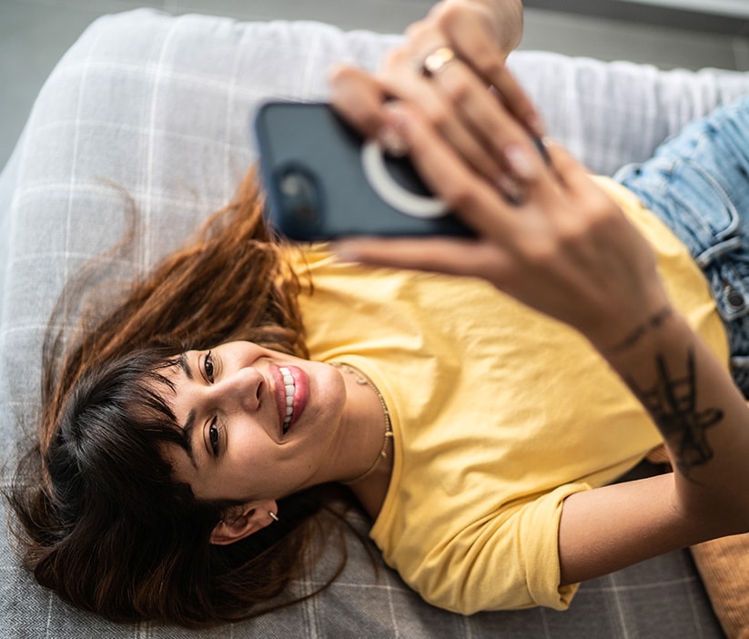 A woman uses her phone to research how to remove personal information from the internet.