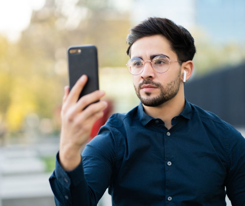 A man uses a common IAM feature—Face ID—to verify his identity and unlock his smartphone. 