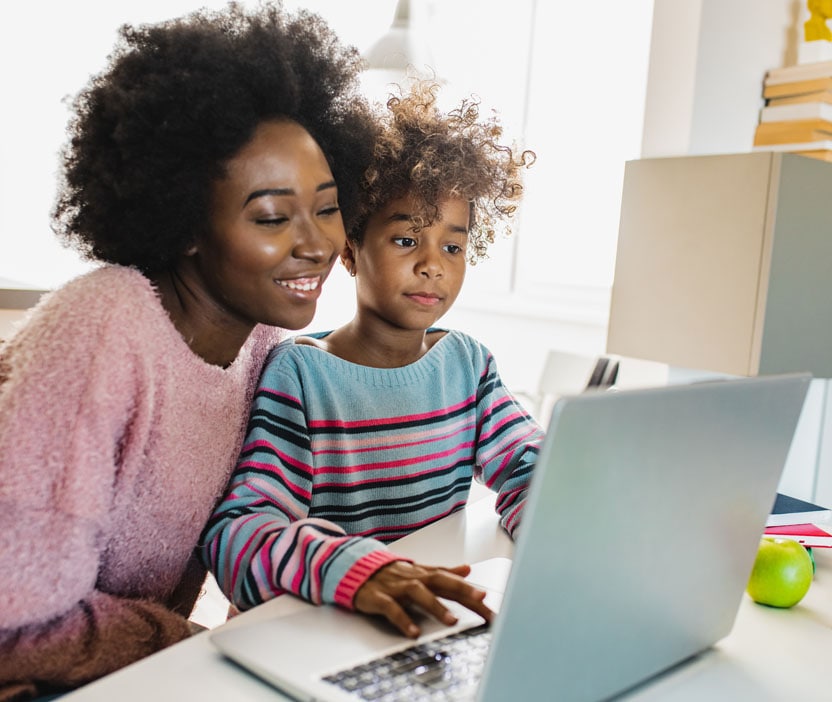 A family on a laptop reading about how to avoid Instagram scams.