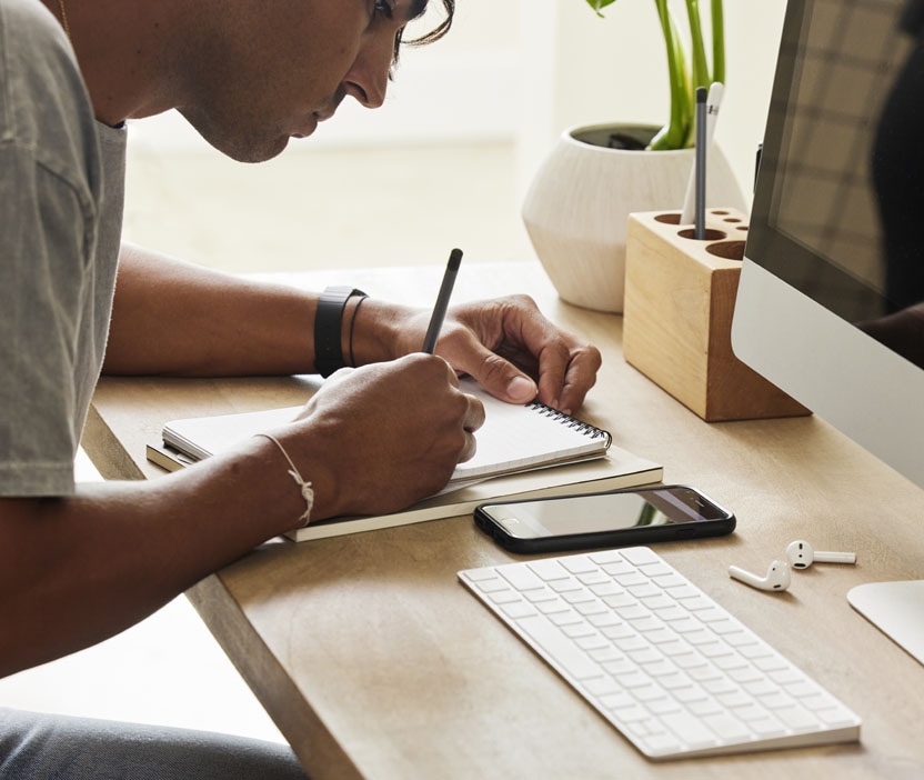 A man writing down ways to protect his computer from a Trojan downloader.