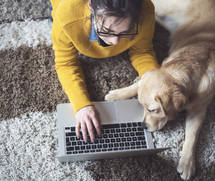 Woman researching gift card scams on her laptop.