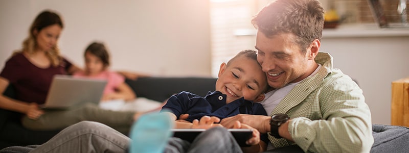 A family enjoys their secure WiFi setup while browsing on their devices.