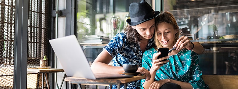 Couple looking on device to see if their names were part of a privacy breach