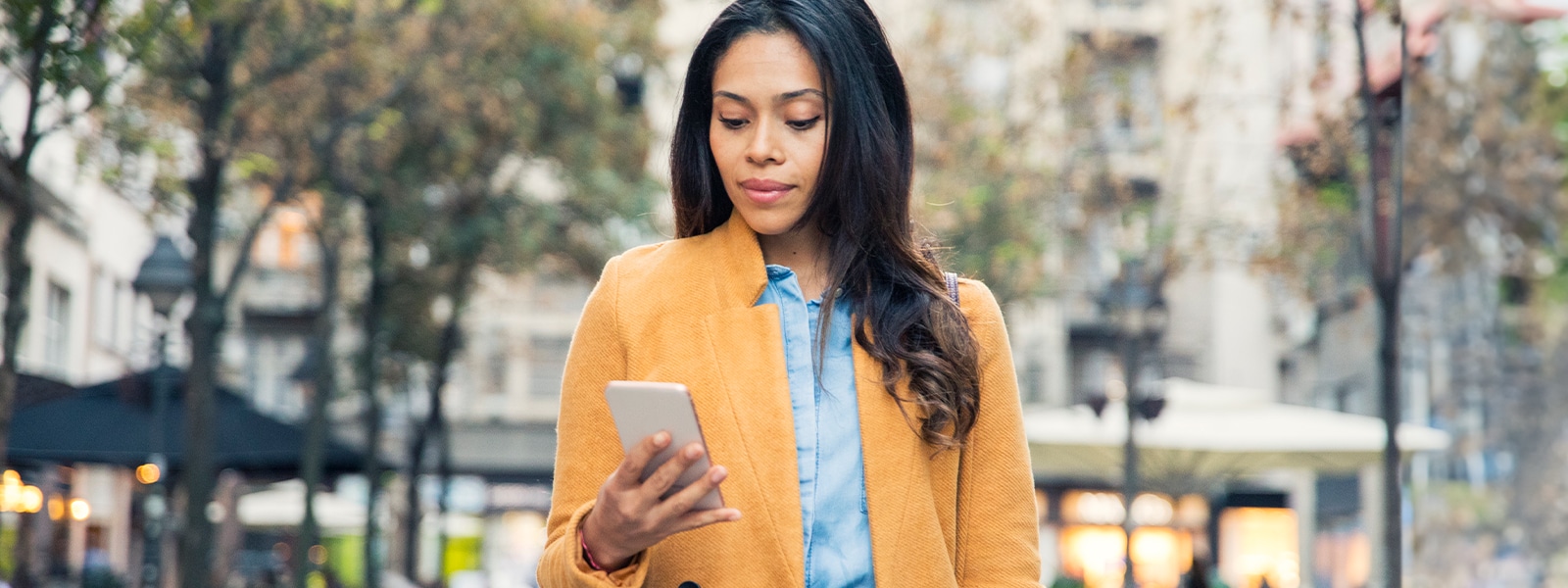 Woman looking at her phone contemplating mobile security.