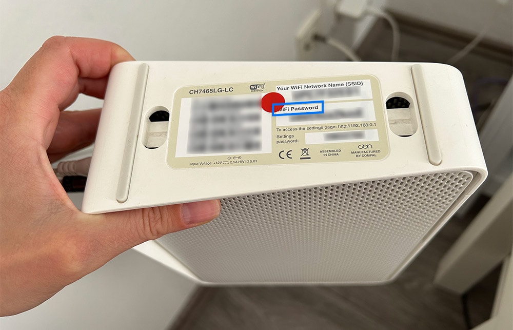 Underside of a router showing the wireless password (network security key).