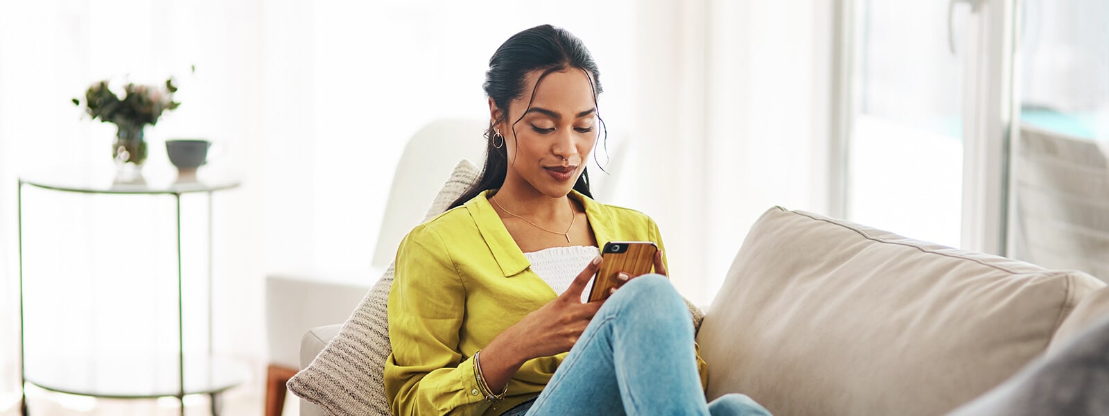 A woman checks the PayPal app. 