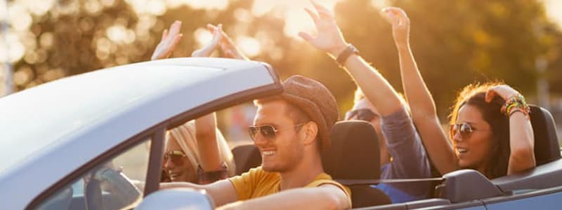 People in a rental car using the infotainment system, illustrating the importance of data security.