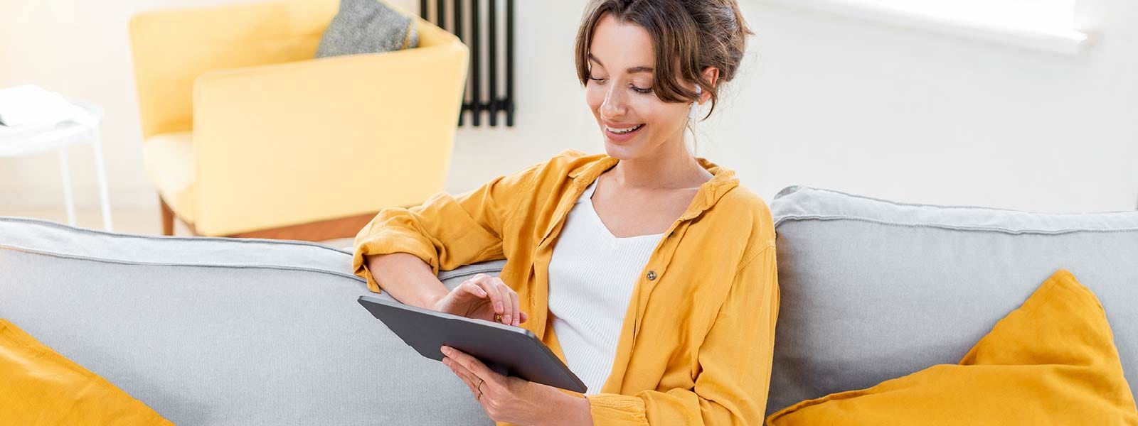 A person smiles while researching riskware on their tablet.