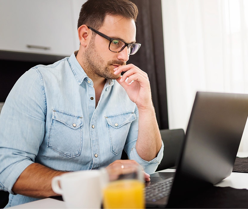 A man reads about a smurf attack on his laptop.