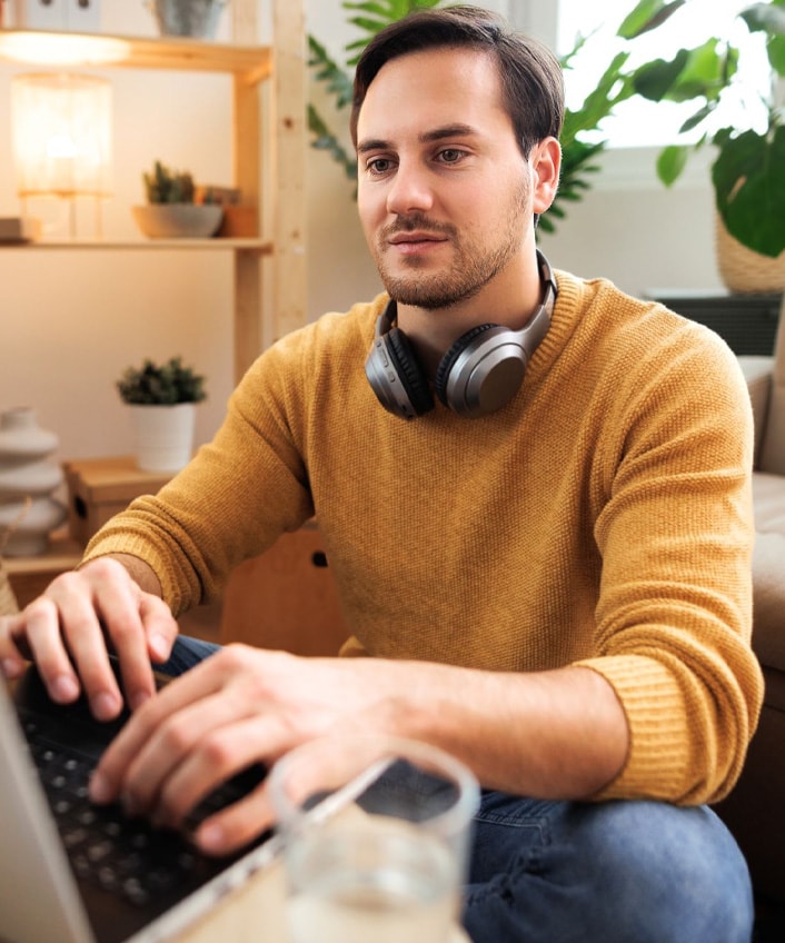 A man sits at his computer and does research to answer the question, “What is a hacker?”