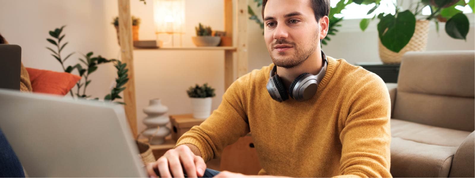 A man sits at his computer and does research to answer the question, “What is a hacker?”