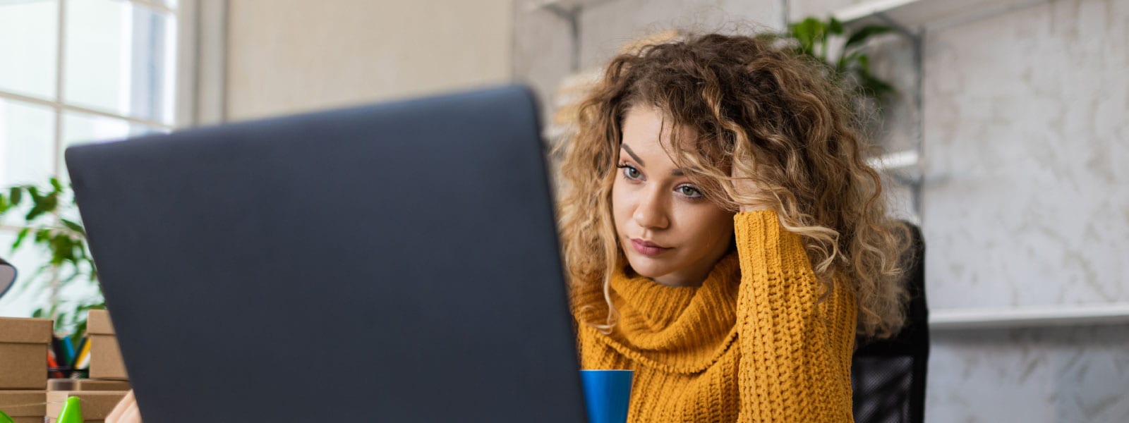 A woman scans her work computer for a computer virus.