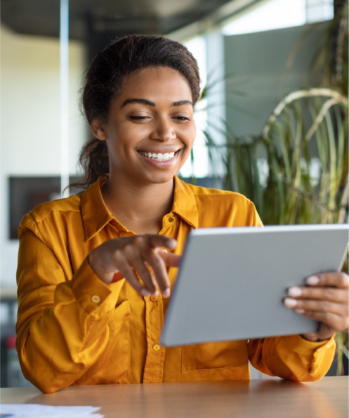 A woman reads about encryption on her tablet, answering the question, "What is encryption?"