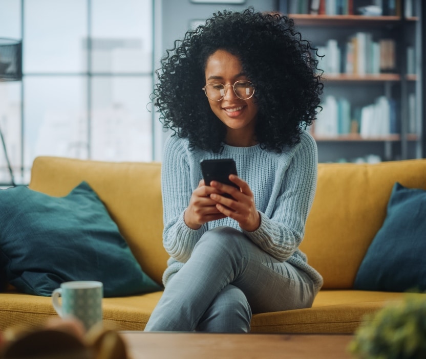 A young woman watches Reesa Teesa’s TikTok saga “Who TF Did I Marry?” on her phone.