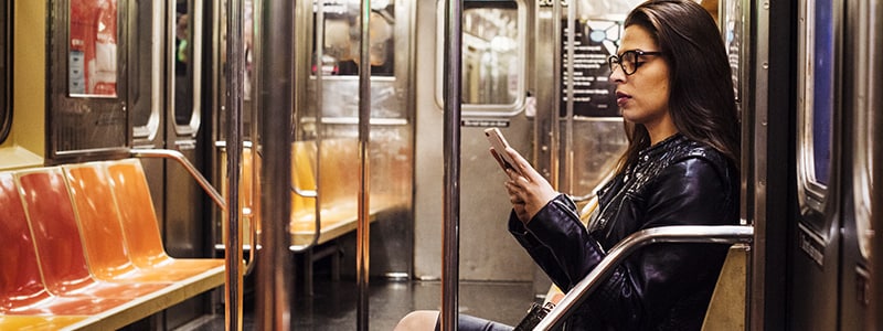 Person on train researching how to stay safe online.