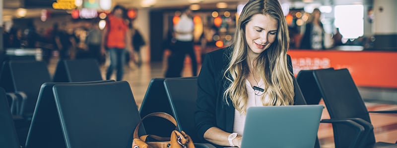 A woman researching hotel Wi-Fi and whether or not it is safe to connect.