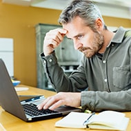 A man purchasing an accessory to cover his webcam on his laptop.