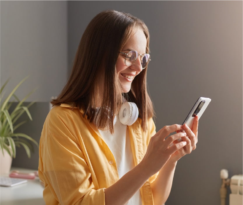 A woman uses a password to unlock her smartphone, an example of cybersecurity basics. 