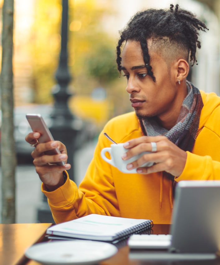 A person connects to public Wi-Fi so he can use his phone while he sits at a local coffee shop. 