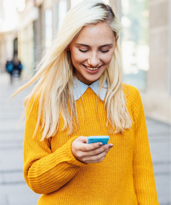 A woman unlocks her phone using facial recognition.