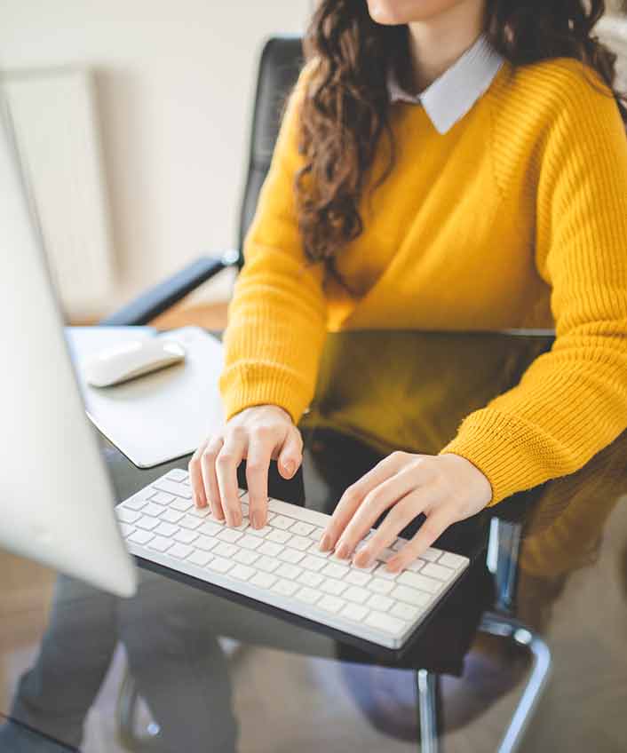 Person typing on a computer to search for how to block websites.