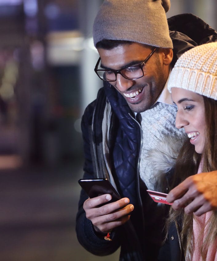 Couple looking at phone researching deep web threats.