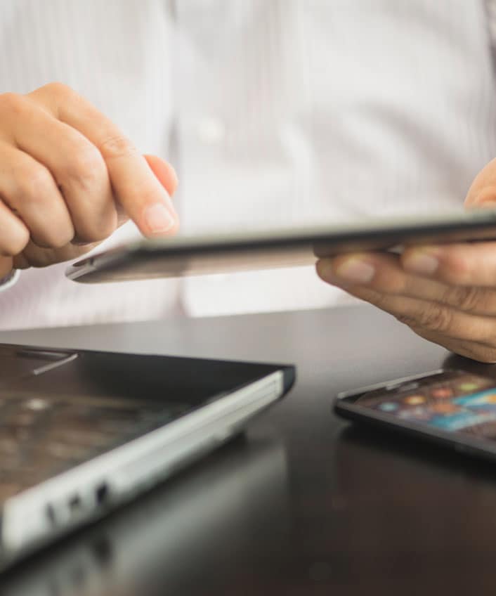 A man protecting himself from phishing attacks by researching prevention tips.