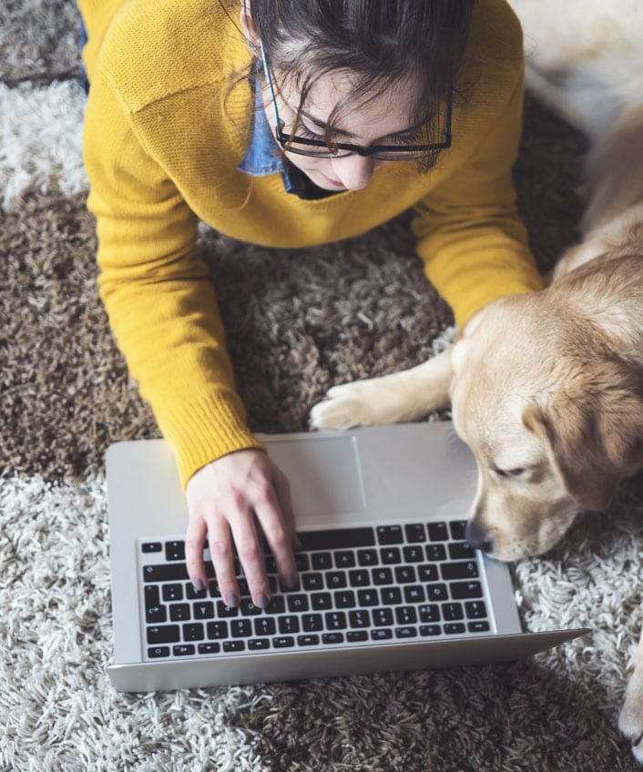 Woman researching gift card scams on her laptop.