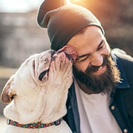 A man and his dog taking a selfie with a secure Android phone.