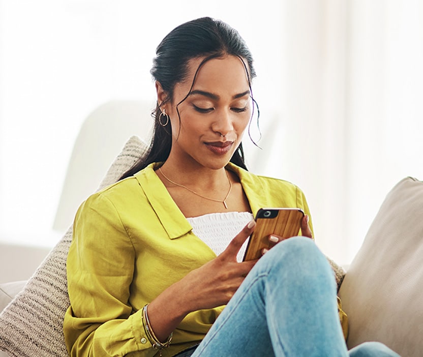 A woman checks the PayPal app. 