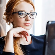 A woman on her computer navigating how to delete the cookies on her device.