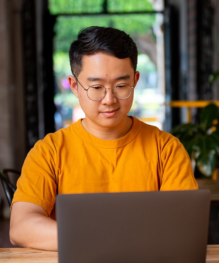 Man on a laptop learning how to update operating systems.