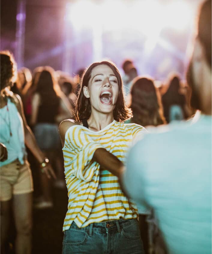 People at a Ticketmaster event having fun in a crowd, most likely a concert.