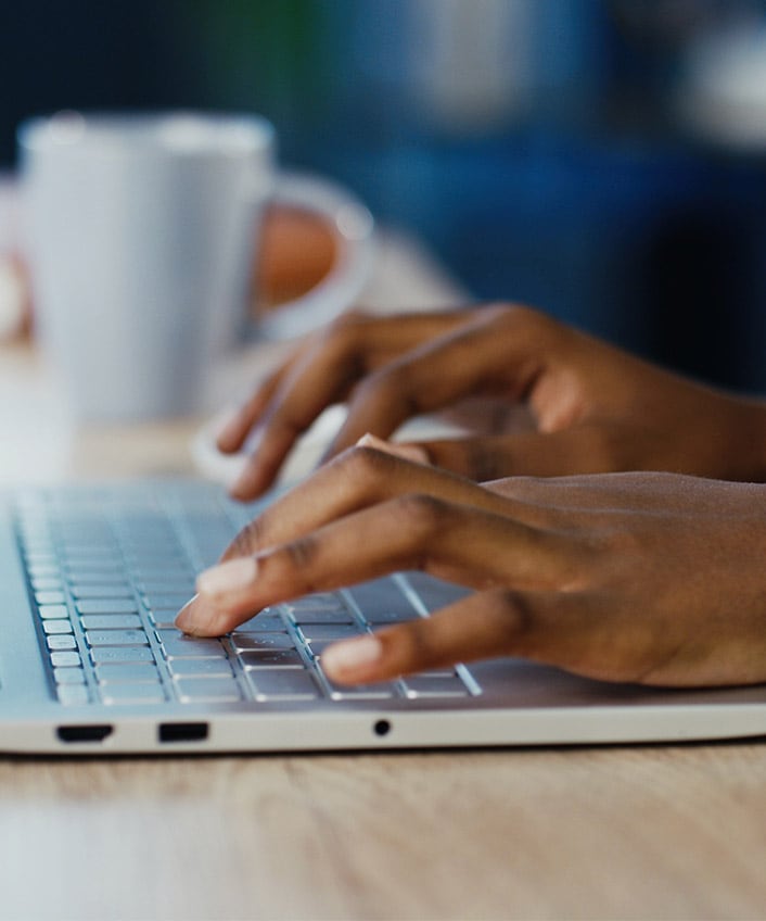 Woman typing on laptop wondering if her keystrokes are being logged.