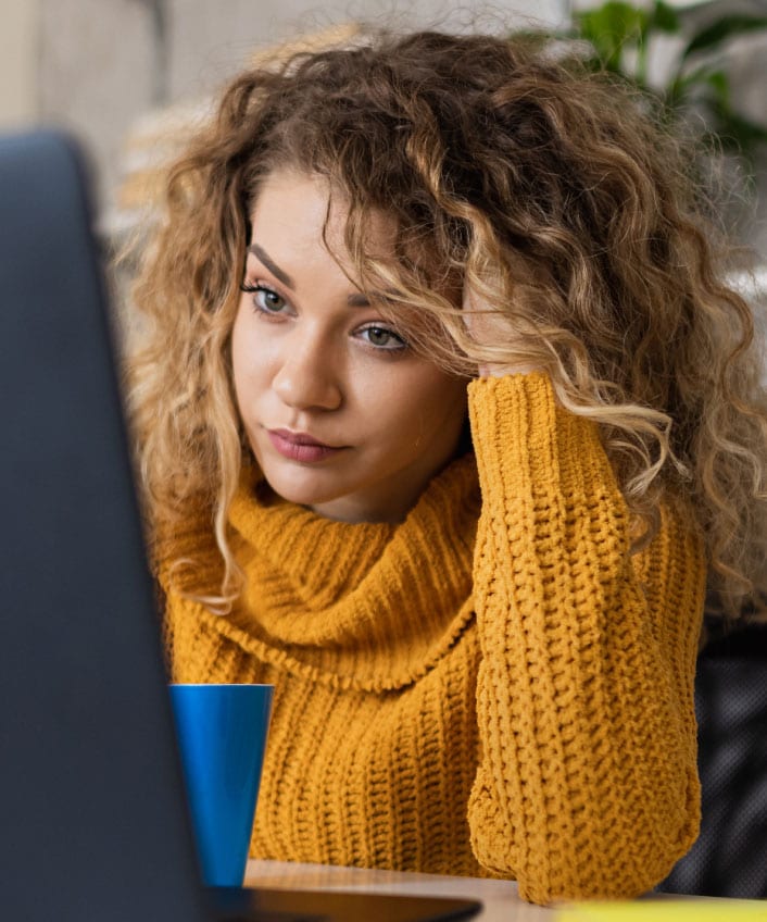 A woman scans her work computer for a computer virus.