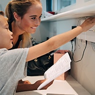 A mother and son setting up a VPN on their home router.