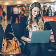 A woman researching hotel Wi-Fi and whether or not it is safe to connect.