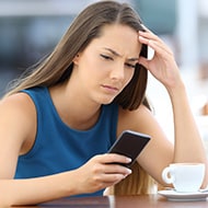 A woman frustrated with a virus on her Android phone, learning how to remove it.