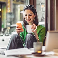 young-woman-with-cell-in-coffee-shop