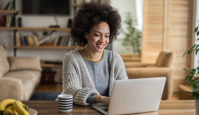 Woman on computer launching Norton 360 with AntiVirus Plus.